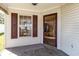 Inviting front porch with tiled flooring and dark red trim door and window shutters with white vinyl siding at 174 Sussex Ct., Longs, SC 29568