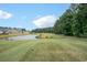 Scenic view of the golf course overlooking the serene lake and lush greenery at 174 Sussex Ct., Longs, SC 29568