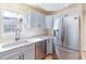 Modern kitchen featuring stainless steel appliances and grey cabinets with dark hardware at 174 Sussex Ct., Longs, SC 29568