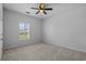 This bedroom features neutral carpet and a window with plantation shutters at 181 Saddle St, Conway, SC 29527