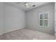 This bedroom features neutral carpet and a window with plantation shutters at 181 Saddle St, Conway, SC 29527
