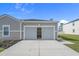 Attached two car garage with a concrete driveway offers convenient parking and storage space for residents and their vehicles at 181 Saddle St, Conway, SC 29527