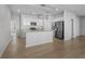 The kitchen boasts stainless appliances, granite countertops, white cabinetry and eat at kitchen island at 181 Saddle St, Conway, SC 29527