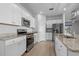 Bright kitchen with white cabinets, granite countertops, and stainless steel appliances at 181 Saddle St, Conway, SC 29527
