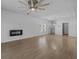 Bright living room featuring wood-look floors, modern fireplace and elegant ceiling fan at 181 Saddle St, Conway, SC 29527