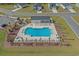 Aerial view of community pool with lounge chairs, surrounded by a secure fence, inviting relaxation and recreation at 181 Saddle St, Conway, SC 29527