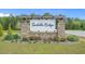Community sign featuring brick columns and manicured landscaping provides a welcoming entrance to Saddle Ridge at 181 Saddle St, Conway, SC 29527