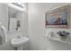 Stylish half bath features a pedestal sink, decorative mirror, and beach-themed decor at 1880 Auburn Ln. # 27 A, Surfside Beach, SC 29575