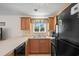 Close-up of kitchen area with wood cabinets and modern appliances, next to window at 1880 Auburn Ln. # 27 A, Surfside Beach, SC 29575