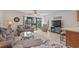 Comfortable living room with plush sofas, a glass coffee table, and access to an outdoor space at 1880 Auburn Ln. # 27 A, Surfside Beach, SC 29575