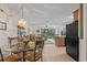 Open-concept living area with dining space, leading to a well-lit living room with a view of the outdoors at 1880 Auburn Ln. # 27 A, Surfside Beach, SC 29575