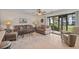 Inviting living room featuring cozy sofas, a glass coffee table, and sliding doors with a view of the garden at 1880 Auburn Ln. # 27 A, Surfside Beach, SC 29575