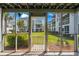 Screened-in patio overlooks a manicured lawn and neighboring condo buildings at 1880 Auburn Ln. # 27 A, Surfside Beach, SC 29575