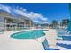 Inviting community pool surrounded by lounge chairs and landscaping provides a relaxing oasis at 1880 Auburn Ln. # 27 A, Surfside Beach, SC 29575