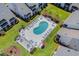 Aerial view of a kidney shaped community pool surrounded by lounge chairs and well manicured grounds at 1880 Auburn Ln. # 27 A, Surfside Beach, SC 29575