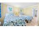 Charming bedroom featuring two twin beds with decorative coastal-themed bedding and lamps at 2001 S Ocean Blvd. # 1303, Myrtle Beach, SC 29577