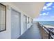 Hallway view with unit entrances, gray doors, ocean view beyond railing, and access to multiple units at 2001 S Ocean Blvd. # 1303, Myrtle Beach, SC 29577