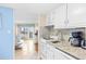 Efficient kitchen space offering granite countertops, white appliances, and bright access to living area at 2001 S Ocean Blvd. # 1303, Myrtle Beach, SC 29577