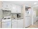 Well-lit kitchen featuring white appliances, granite countertops, and ample cabinet space at 2001 S Ocean Blvd. # 1303, Myrtle Beach, SC 29577