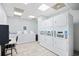 Well-lit laundry room with multiple rows of white washing machines and dryers, plus a work station at 2001 S Ocean Blvd. # 1303, Myrtle Beach, SC 29577