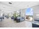 Open lobby area with comfortable seating, decorative plants, tile flooring, and arched windows overlooking pool at 2001 S Ocean Blvd. # 1303, Myrtle Beach, SC 29577