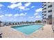 Exterior pool area featuring clear blue water, lounge chairs and an ocean view at 2001 S Ocean Blvd. # 1303, Myrtle Beach, SC 29577