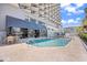 Exterior pool area featuring blue water, surrounding brickwork, hotel exterior and a pizza restaurant at 2001 S Ocean Blvd. # 1303, Myrtle Beach, SC 29577