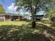 Expansive backyard features a large grassy area, mature trees, and storage, perfect for outdoor activities at 2005 Loblolly St., Georgetown, SC 29440