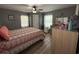 Cozy bedroom featuring neutral walls, a ceiling fan, a colorful bedspread, and an open-concept closet at 2005 Loblolly St., Georgetown, SC 29440