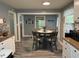 Cozy dining area with a round table, chairs, and views into the kitchen at 2005 Loblolly St., Georgetown, SC 29440
