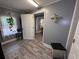 Inviting entryway featuring wood-look tile floors, a grey accent wall, and natural light from the window at 2005 Loblolly St., Georgetown, SC 29440