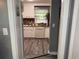 View of the kitchen, featuring white cabinets and modern fixtures from the doorway at 2005 Loblolly St., Georgetown, SC 29440