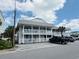 A two-story condo building with white railing around the balconies, with blue sky and clouds above at 202 28Th Ave. N # 5, North Myrtle Beach, SC 29582