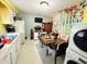 A functional kitchen with appliances, small dining table, laundry hook ups and painted accent wall at 202 28Th Ave. N # 5, North Myrtle Beach, SC 29582