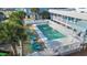 Inviting pool area surrounded by palm trees, sun loungers, and white picket fence at 202 28Th Ave. N # 5, North Myrtle Beach, SC 29582
