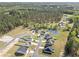 Expansive aerial view of a neighborhood with mature trees, a pond, and well-maintained lawns at 204 Palmetto Sand Loop, Conway, SC 29527