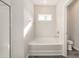 Clean bathroom featuring a tub, a toilet and a bright window for natural light at 204 Palmetto Sand Loop, Conway, SC 29527