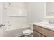The white-tiled bathroom has a shower and tub combination, along with a modern vanity at 204 Palmetto Sand Loop, Conway, SC 29527