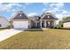 Inviting single-story home with a two-car garage, well-manicured lawn, and attractive facade at 204 Palmetto Sand Loop, Conway, SC 29527