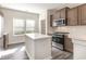 Charming kitchen featuring stainless appliances, center island, and wood flooring at 204 Palmetto Sand Loop, Conway, SC 29527