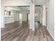 Bright, open-concept living room with wood-look floors and a partial view into the kitchen area at 204 Palmetto Sand Loop, Conway, SC 29527