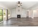 Bright living room featuring built-in shelving, vaulted ceiling, fireplace, and wood-look floors at 204 Palmetto Sand Loop, Conway, SC 29527