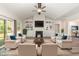 Staged living room with built-in shelving, fireplace, wood-look floors, and comfortable seating arrangement at 204 Palmetto Sand Loop, Conway, SC 29527