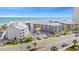 Scenic aerial shot of condos featuring parking, landscaping, and ocean views at 208 Ocean Blvd. N # 228, North Myrtle Beach, SC 29582