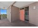 Exterior condo entrance with covered balcony and ocean view; featuring a bright colored door at 208 Ocean Blvd. N # 228, North Myrtle Beach, SC 29582