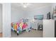 Bright bedroom with a colorful floral quilt, a flamingo plushie, and coastal artwork, creating a cheerful space at 208 Ocean Blvd. N # 228, North Myrtle Beach, SC 29582