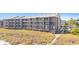 Beachfront condo building with multiple levels of screened in porches, close beach access, and beautiful landscaping at 208 Ocean Blvd. N # 228, North Myrtle Beach, SC 29582