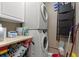 Efficient laundry area featuring a stacked washer and dryer, storage, and cleaning supplies at 208 Ocean Blvd. N # 228, North Myrtle Beach, SC 29582