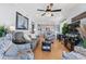 Open-concept living room with comfortable seating, a modern ceiling fan, and seamless flow into the kitchen and dining area at 208 Ocean Blvd. N # 228, North Myrtle Beach, SC 29582