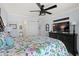 Bright main bedroom featuring a ceiling fan, dark dresser, and access to the main bathroom at 208 Ocean Blvd. N # 228, North Myrtle Beach, SC 29582